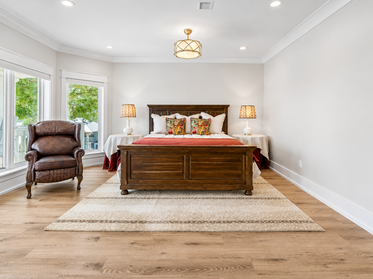 Luxury master bedroom with hardwood floors and custom trim