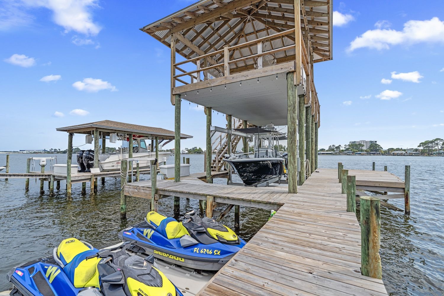 Multi-slip boat dock with boathouse and jet skis